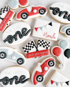 decorated cookies are arranged in the shape of race cars