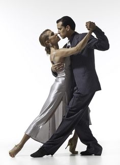 a man and woman are dancing together on the danceflosse floor with their arms around each other