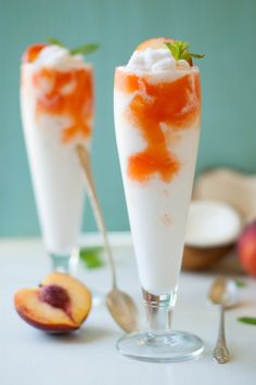 two glasses filled with ice cream and peaches