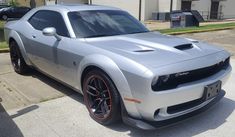 a silver sports car parked on the side of the road