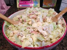 a red bowl filled with salad on top of a counter