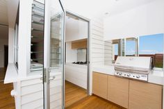 a kitchen with white walls and wooden floors