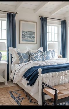 a bedroom with blue and white decor in it