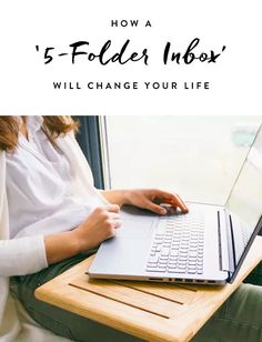 a woman sitting in front of a laptop computer on top of a wooden table with the title how a 5 - folder inbox will change your life