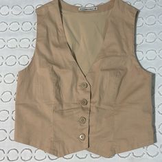 This Beautiful Vest Has Never Been Worn. I Bought It And I Was Hoping For A Looser Fit. It’s A Size Medium And It Has Some Stretch But Also Super Good Structure Material. It’s Very Flattering And So So Comfortable. (It’s Super Soft) I Also Have The Matching Skirt If Interested Fitted Beige Vest Outerwear, Beige Fitted Vest Outerwear, Fitted Beige Vest With Button Closure, Classic Beige Vest Top, Beige Button-up Vest For Work, Fitted Khaki Vest For Work, Vintage Beige Workwear Vest, Vintage Vest For Spring Workwear, Beige Vest