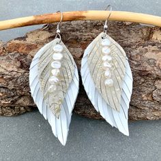 "A Large, Long, Creamy White Leather Feather Earring with Elegant Rose Gold Embossing. Designed to float on the breeze like a real Feather! Accented with gorgeous Keshi Pearls that seem to have their own inner glow! Surgical Stainless Steel Earwires. A stunning Summer Earring or Statement Earrings for a Bride! A long,dangle Leather Earring-sure to be noticed! 2Sizes Available: *Long-3 5/8\"total length-Leather Part is 3\"x 1 3/8\" *Longer-4 1/8\"total length-Leather Part is 3 1/2\"x 1 5/8\" Earr Leather Dangle Jewelry For Party, Handmade White Leather Earrings, Party Leather Dangle Jewelry, Elegant Faux Leather Earrings As Gift, Handmade Faux Leather Dangle Jewelry, White Leather Earrings As A Gift, White Leather Earrings For Gift, White Leather Earrings Gift, Silver Leather Dangle Earrings