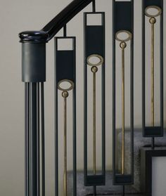 a set of stairs with black and gold railings