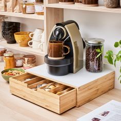 an espresso machine sitting on top of a wooden box filled with coffee beans