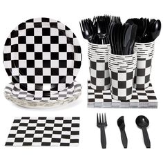 black and white checkerboard plates, forks, spoons and napkins are arranged in front of each other