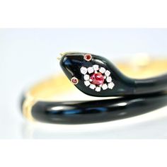 This is part of Chairish’s Fine Jewelry assortment.  Black Enamel Snake Bracelet 18K Ruby Head  This Black Enamel Snake bracelet is in perfect condition. No scratches dents or enamel loss just pristine and gorgeous. This snake is made with 18K yellow gold and it measures 6.5 so it fits a size 6 to a size 7. It weighs 51.8 grams of gold, very substantial. This bracelet has a Ruby head, Ruby eyes and small Diamonds surrounding the large Ruby. The Ruby weighs in at 1/2 of a carat and there are 12 s Luxury Yellow Gold Enamel Bangle, Luxury Collectible Round Bangle, Designer Enamel Bangle Jewelry, Luxury Enamel Bangle Bracelets, Designer Yellow Gold Enamel Jewelry, Formal Yellow Gold Enamel Bracelets, Luxury Enamel Bangle As Gift, Luxury Enamel Bangle For Gift, Yellow Gold Enamel Round Bracelet