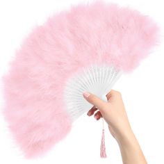 a hand holding a fan with pink feathers