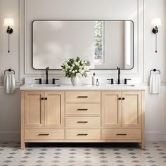 a bathroom with two sinks and a large mirror on the wall over it's counter