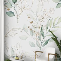 a white chair sitting in front of a wall with green leaves on it