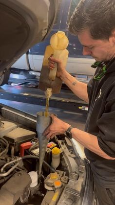 a man working on an engine in a car