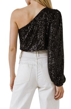 Twinkling sequins come to life on this party-ready crop top that has a single puff sleeve and a shoulder-baring silhouette. One-shoulder neck Single long sleeve Lined 100% polyester Hand wash, dry flat Imported Sequin Crop Top For Party, Contrast Sequin Cropped Top For Evening, Cropped Crop Top With Contrast Sequin For Evening, Cropped Contrast Sequin Party Top, Evening Sequin Crop Top, Evening Sequined Crop Top, Contrast Sequin Cropped Top For Party, Party Cropped Top With Contrast Sequin, Fitted One Shoulder Top For Spring Party