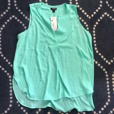 Nwt A.N.A. Mint Green Sleeveless High-Low Blouse. Beautiful Lightweight, Chiffon Feeling Mint Green Shirt. ***Even Though This Is A “Petite Large”... It’s Long And Will Fit Someone Who Isn’t Petite. Since It’s High Low Hem... I’ll Provide Measurements Of Front & Back. Laying Flat: Front: Shoulder To Bottom Hem - 25” Back: Shoulder To Bottom Hem - 30” Sleeveless Blouse For Summer Layering, Sleeveless Summer Tops For Layering, Summer Sleeveless Tops For Layering, Green Sleeveless Summer Blouse, Spring Tank Blouse, Sleeveless Summer Camisole For Layering, Sleeveless Layering Camisole For Summer, Summer Sleeveless Camisole For Layering, Green Sleeveless Blouse For Vacation