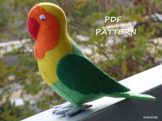 a colorful bird sitting on top of a window sill