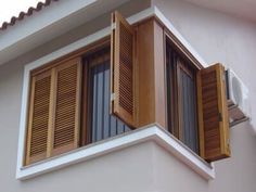 an apartment building with wooden shutters and balconies