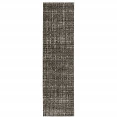 the runner rug is made from dark grey fabric with an uneven pattern on top and bottom