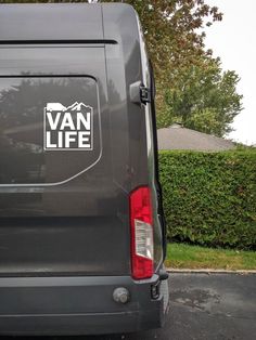 van life sticker on the back of a van parked in front of a house