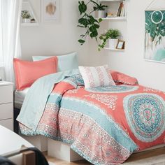 a bed room with a neatly made bed and a plant on the wall behind it