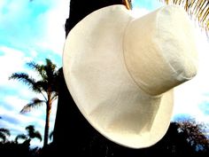 A beautiful and classic wide brim hat in Off-White ....Classic and Elegant.A touch of elegance with this Ivory big hat in linen and a look of style. Chic and unique in it's look yet it is perfectly suited for casual events ~ beach-goer, walking, shopping, gardening, . . .Brims are made perfectly wide enough to protect the face and neck from sun exposure and can be folded up at the front, side, or back for a versatile look - and the shape will hold. A great hat for vacation or travels as it packs Elegant Natural Panama Hat, Elegant Cream Panama Hat With Flat Brim, Elegant Natural Brimmed Hat, Elegant Natural Color Sun Hat With Flat Brim, Elegant Natural Sun Hat With Flat Brim, Elegant Brimmed Hat In Natural Color, Elegant Cream Hat For Vacation, Elegant Cream Brimmed Panama Hat, Elegant Natural Brimmed Sun Hat