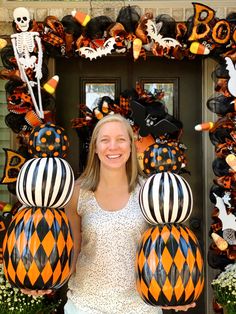 a woman standing in front of a door decorated with halloween decorations