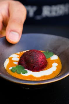 a person reaching for a dessert on a plate