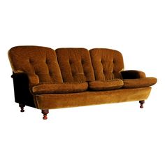 a brown couch sitting on top of a wooden table