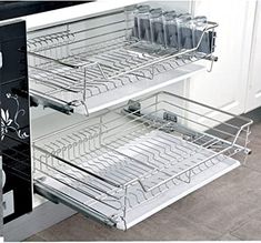 an open drawer in a kitchen next to a stove