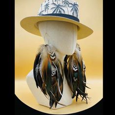 a mannequin wearing a hat with feathers on it