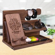 a wooden desk organizer with sunglasses and other items