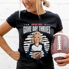 Huddle up for this vintage-inspired pin up football shirt! Featuring a retro pin up cheerleader graphic, it's perfect for football fans and lovers of pin up style. Makes a great gift for any cheerleader fan! Hello there! 😊👋 If you're on the hunt for some seriously cozy T-shirts, you've come to the right place! I'm absolutely passionate about what I do, and my mission is to make your shopping experience absolutely perfect. If you ever have any questions, concerns, or just want to chat about my products, feel free to reach out to me anytime. 👕 Unisex Sizing, Easy Fit! 👕 Unisex sizing(Size chart is in the image) - Shirts are unisex sizing. That means they run slightly larger than women's shirts and slightly smaller than typical men's shirts, almost true to size. Please check the size char Retro College T-shirt For Football Season, Cheerleading Fan Apparel Tops For Football Season, Retro Crew Neck Tops For Game Day, Retro Tops For College Football Season, Vintage Graphic T-shirt For Football Season, Vintage Graphic Print Football T-shirt, Vintage Graphic Print T-shirt For Football Season, Retro Fan Gear Tops For Sports Season, Retro Tops For Sports Season Fan Gear