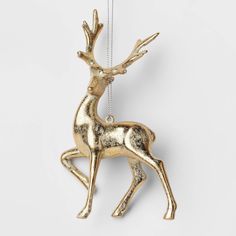 a gold reindeer ornament hanging from a chain