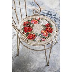 an iron chair with flowers painted on it