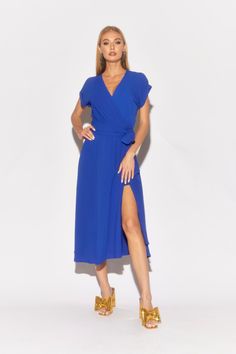 Make a striking entrance in this royal blue midi dress from Meghan LA. Featuring a flattering surplice V-neckline and elegant cuffed bell sleeves, it adds a touch of sophistication to any occasion. The elastic waist with a self-tie belt ensures a comfortable fit, while the flowing mid-length skirt creates graceful movement. Crafted from butter-soft fabric in a bold royal blue, this dress is perfect for fall events. Available in plus sizes. Spring Midi Belted Dress, Belted Midi Dress For Spring, Solid Belted Midi Dress For Spring, Belted Solid Midi Dress For Spring, Spring Midi Length Belted Dress With Tie Waist, Spring Solid Color Belted Maxi Dress, Formal Maxi Dress With Surplice Neckline For Spring, Solid Color Maxi Dress With Surplice Neckline For Spring, Spring Formal Solid Wrap Dress