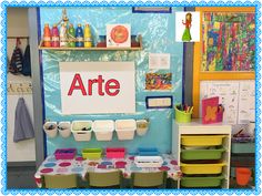 an art room with lots of crafting supplies on the table and shelves in front of it