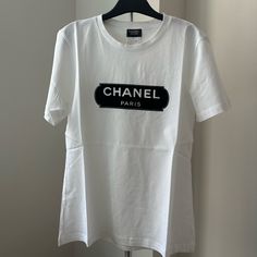 100 Authentic Chanel Uniform T-Shirt Size Xs Brand New White Crew Neck T-shirt With Designer Logo, Luxury White T-shirt With Letter Print, Casual White T-shirt With Designer Logo, White Casual T-shirt With Designer Logo, Trendy White Top With Logo, Designer Graphic Tee With Crew Neck, Designer Logo Graphic Tee With Crew Neck, Graphic Tee With Designer Logo And Crew Neck, White Designer Logo T-shirt