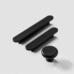 two black knobs and one black door handle