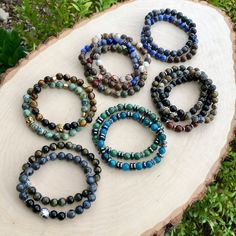 "These beautiful natural stone stretch beaded bracelets are intended for men or women. I love the way these turned out and made them with two stone bead choices. However, they also look great worn together. #1 BLUE APATITE & HEMATITE #2 SOUTH AFRICAN GREEN JADE & HEMATITE They are only available in sizes from 6.5\" to 8.5\". The round stone beads are 8mm in size. I also have other coordinating bracelets as shown in the photos, should you like to stack them, sold separately. Jewelry items Casual Crystal Bracelet With Natural Round Beads, Casual Agate Beaded Bracelets With Gemstone Beads, Casual Agate Gemstone Beaded Bracelets, Casual Stretch Bracelet With Natural Round Beads, Casual Stretch Bracelet With Natural Stones, Casual Stretch Bracelet With Round Natural Stones, Blue Amazonite Beaded Bracelets With Gemstone Beads, Blue Jade Beaded Bracelets For Healing, Blue Apatite Jewelry With Gemstone Beads