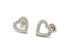 Product Description: These Sterling Silver Heart Stud Earrings with Cubic Zirconia are a sparkling addition to any jewelry collection. Delicately handcrafted from high-quality recycled silver, these earrings feature a minimalist heart shape embellished with lustrous cubic zirconia gemstones. Measuring at 9 millimeters in length and 8 millimeters in width, these earrings are designed to sit comfortably on the earlobe. The push back closure ensures they stay securely in place. Highlights: - Handma Minimalist Heart Cut Sterling Silver Earrings, White Gold Sterling Silver Open Heart Earrings, Silver Heart-shaped Cubic Zirconia Diamond Earrings, Fine Jewelry Sterling Silver Heart Earrings Brilliant Cut, Heart Shaped Sterling Silver Diamond Earrings, Heart-shaped White Gold Cubic Zirconia Earrings, Valentine's Day Brilliant Cut Diamond Earrings In Sterling Silver, Dainty White Gold Heart Earrings With Cubic Zirconia, Elegant Sterling Silver Heart Earrings With Vvs Clarity