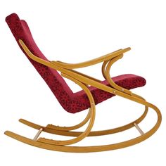 a wooden rocking chair with red upholstered fabric