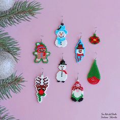 six christmas ornaments are hanging on a pink background next to a fir tree and snowman ornament