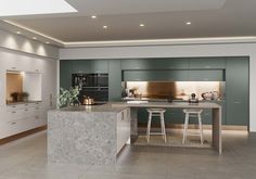 an image of a modern kitchen setting with marble counter tops and stools in the center