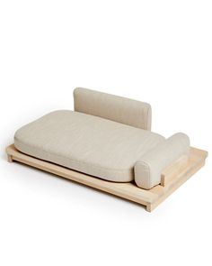 a couch that is sitting on top of a wooden stand with a pillow attached to it