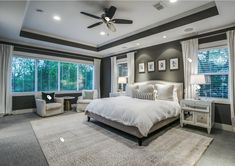 a bedroom with gray walls and white furniture