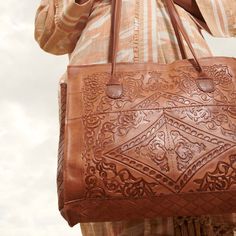 The Embossed Soft Leather Tote from Jerusalem Sandals combines fine craftsmanship and timeless style in a handbag that completes any wardrobe. Carry the weight of the world more easily in this handcrafted tote made from chemical-free 100% vegetable tanned leather for years of gorgeous utility. The main compartment of our brown leather tote is roomy enough for your laptop and other devices with a full zipper for security. Double matching straps provide sturdy comfort as you commute to the office Embossed Double Handle Shoulder Bag For Everyday Use, Everyday Double Handle Embossed Shoulder Bag, Elegant Embossed Tote Bag, Embossed Shoulder Bag With Top Handle For Everyday Use, Embossed Top Handle Shoulder Bag For Everyday Use, Embossed Top Handle Shoulder Bag For Travel, Embossed Top Handle Bag For Travel, Everyday Embossed Tote Satchel, Embossed Top Handle Travel Bag