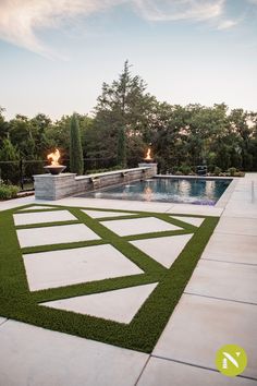 an outdoor swimming pool with artificial grass