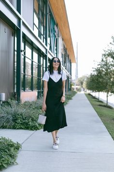 Black Dress Over Shirt, Dress With A Tshirt Outfit, Tank Top Dress With Shirt Under, Slip Dress With Shirt Under, Satin Dress With Shirt Under, White Top Under Dress, Layered Spaghetti Strap Dress Outfit, White Shirt Black Dress Outfit, Slip Dress T Shirt Outfit