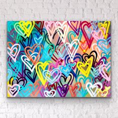 an abstract painting with many hearts painted on the side of a white brick wall in bright colors